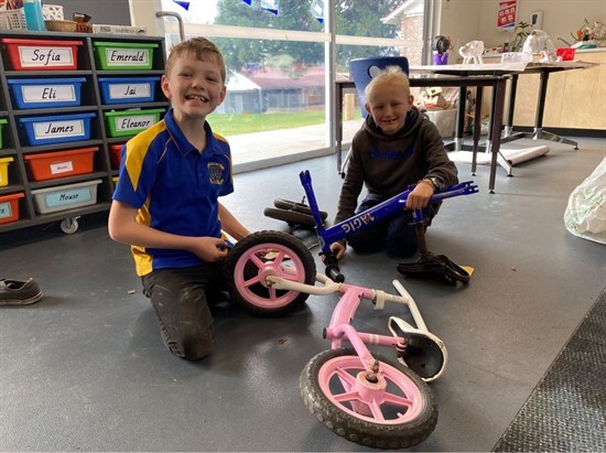 Newsletter week 10, term 2 - Lincoln and Brady working on bikes