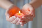 hands_cupped_candle_flame_TS_126448961.jpeg