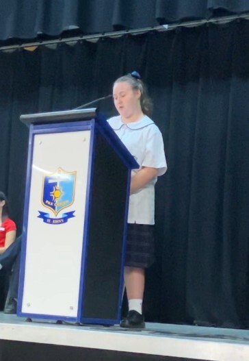 Belle speaking at assembly