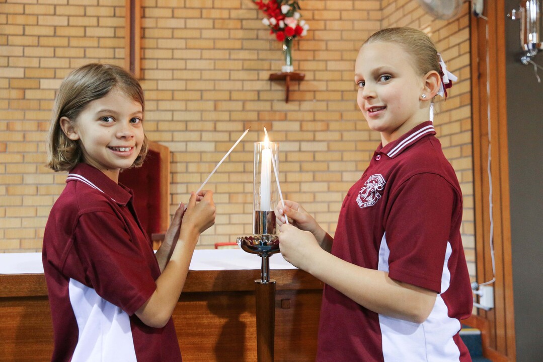 students lighting candles